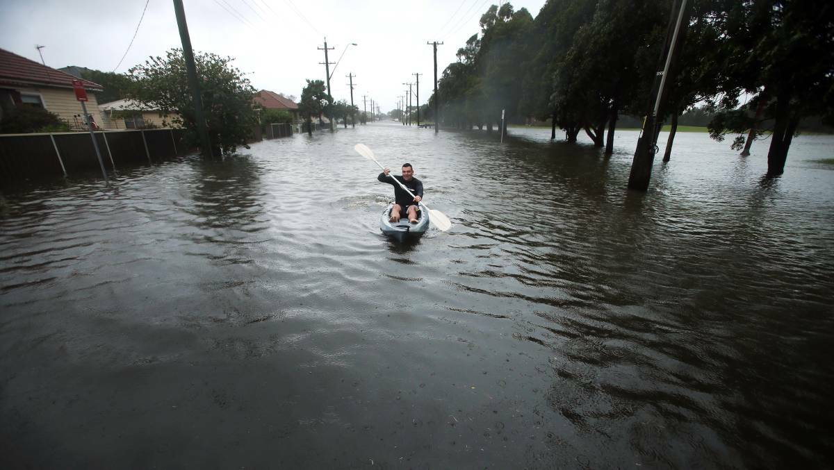 Justin Craig got his kayak out surveying the damage around the property and surrounding streets - and organising a plan of action for his family. Picture: Sylvia Liber