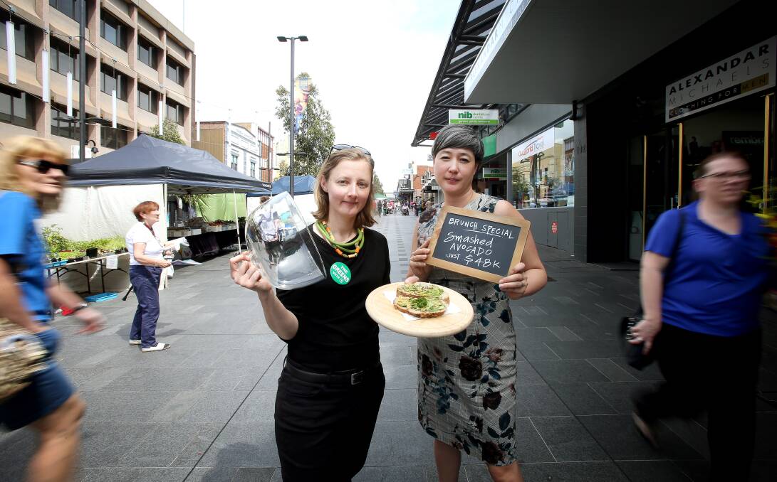 BRUNCH TIME: The Greens' Wollongong byelection candidate Cath Blakey (left) joins Greens MP, and the party's housing spokeswoman, Jenny Leong to offer shoppers a $48,000 smashed avocado on Friday. Picture: Sylvia Liber