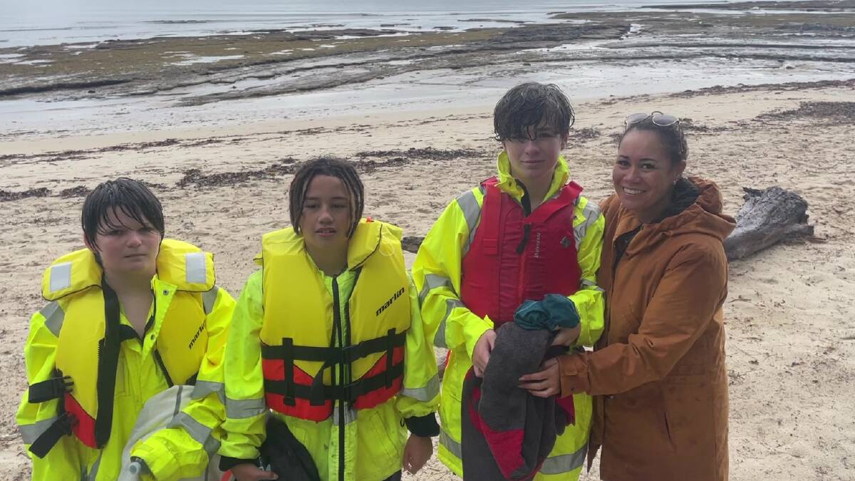 Three boys after they were rescued almost one kilometre off Jervis Bay on Monday, May 6, 2024. They are pictured with Maraea who is mum to two of the boys. Picture by Marine Rescue NSW