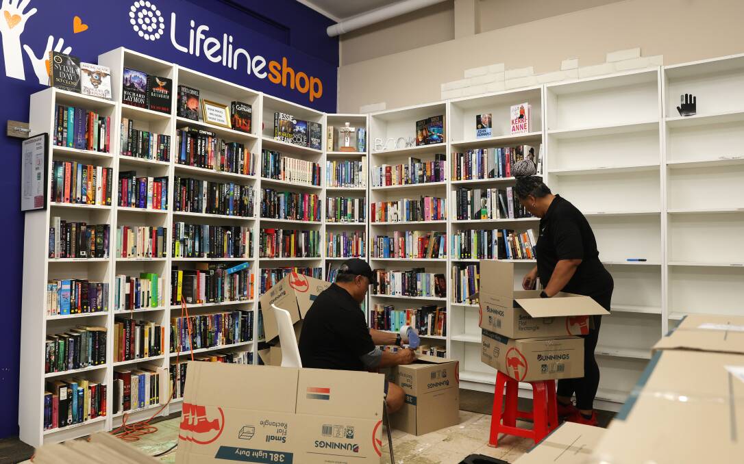 Books being packed away so flood-damaged shelving can be thrown out. Picture by Sylvia Liber