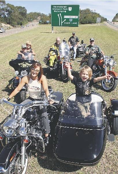 Tracey and Cooper Lunam with their sidecar surrounded by Illawarra Harley owners, (left to right) Bob and Jen Johnston, Steve Arthur, Glenn Southwell and Trevor Gillett. Picture: STEVE LUNAM