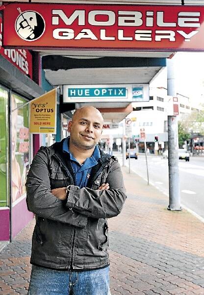 Sean Thakur of Mobile Gallery, which relocated to Crown St from the Keira St corner two years ago because it was afraid of being caught out at the last minute by the proposed GPT retail development. Pictures: SYLVIA LIBER