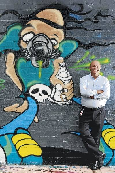 Wollongong City Council's Armando Reviglio at a legal aerosol art wall. He said the initiative was paying off and the council was spending less on cleaning up graffiti. Picture: ROBERT PEET