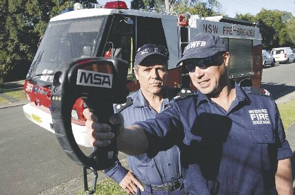 NSW Fire Brigade Dapto station manager Darin Sullivan and senior firefighter Richie Braga with the new thermal imaging camera, which can search a burning building remotely. Picture: DAVE TEASE