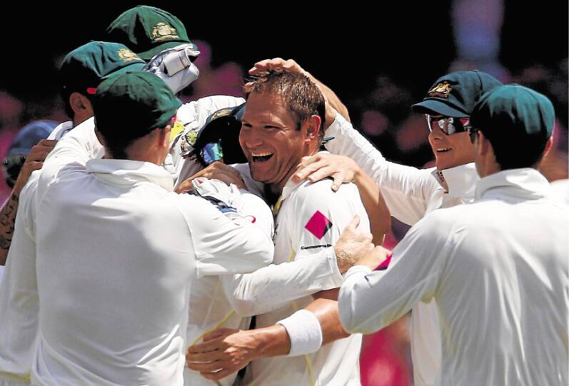 Workhorse: Ryan Harris is mobbed by teammates after snaring Kevin Pietersen's wicket at the SCG. Picture: REUTERS