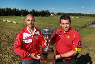 Albion Park coach Alfredo Esteves (left) and his Wollongong United counterpart Steve Micevski with the Bert Bampton Cup. Picture: ORLANDO CHIODO