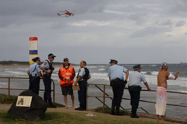 Police and emergency services personnel at  Towradgi rock pool during last night's search.  Picture: KEN ROBERTSON