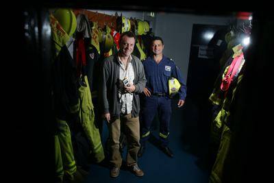 Firefighter Paul Camilleri (right) with Ghost Hunters Wollongong member Paul McCaffrey at Warrawong Fire Station. Picture: KEN ROBERTSON