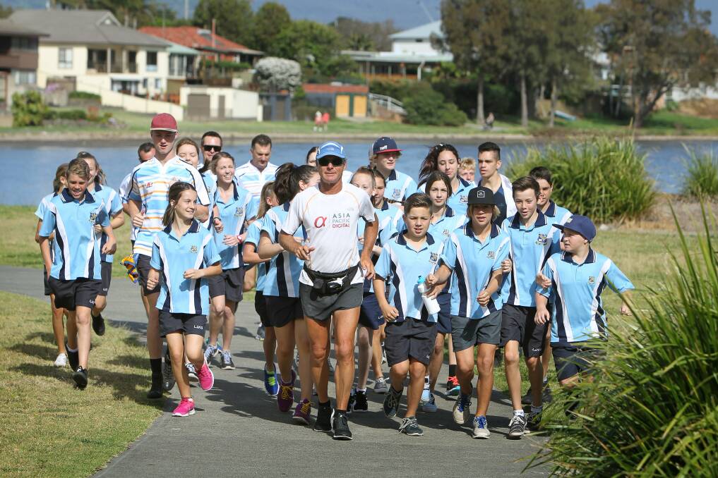 Tom Denniss is greeted by students from Lake Illawarra High School. Picture: SYLVIA LIBER