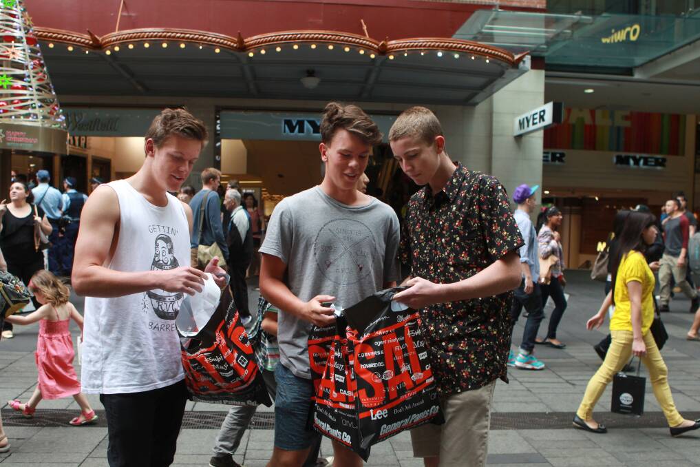 An early start for shoppers Jake Davidson, 16, Lachlan Ritchie, 17, and Cole Lynch, 17. Picture: JACKY GHOSSEIN