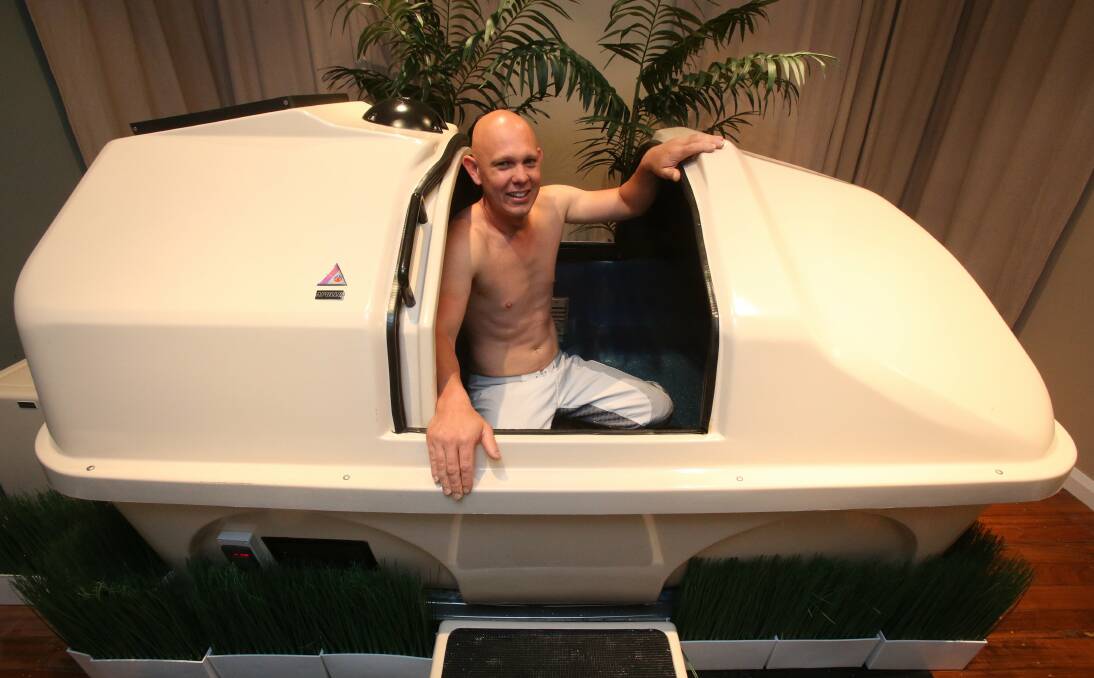 A client hops into the float tank at Cocoon Floatation. Picture: ROBERT PEET