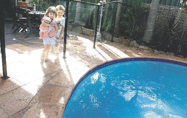 Corrimal kids Zoe Cram, 4, and her brother Darcy, 5, at a friend's home which has full safety approved pool fences. Picture: SYLVIA LIBER