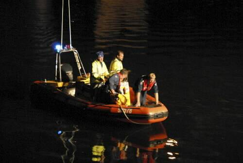 Police divers search the Shoalhaven River on Sunday night. Picture: GLENN ELLARD