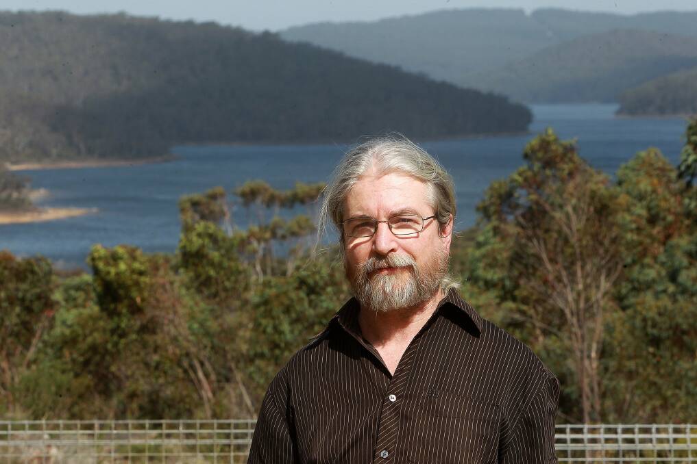 Peter Turner, of the Northern Illawarra Sustainability Alliance, with the Cordeaux Dam in the background.. Picture: GREG TOTMAN
