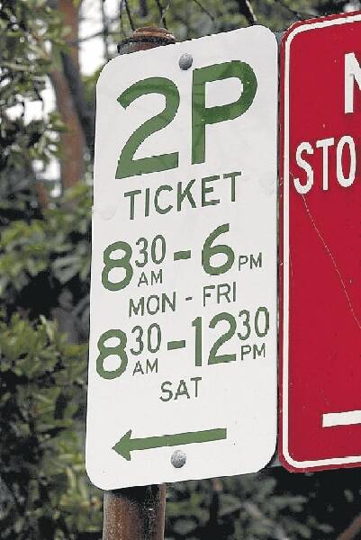 A two-hour parking sign and (below) nearby one-hour ticket machine on Market St yesterday.