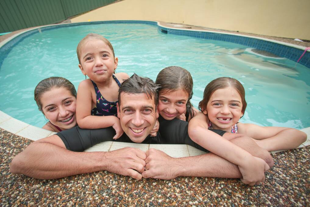 Dr Justin Coulson with four of his five children, from left: Chanel, 14, Lilli, 3, Ella, 10 and Annie, 6, at their Figtree home. Picture: ADAM MCLEAN