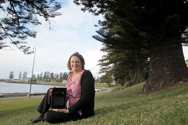 Kiama information services librarian Sharon Jones is encouraging users of smartphones and tablet devices to take an interactive tour of Kiama launched this week. Picture: DAVE TEASE