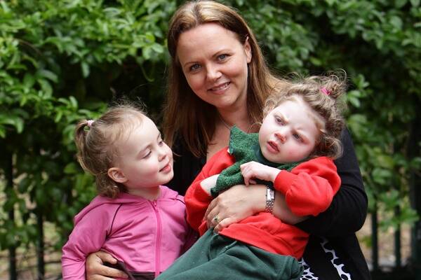 Mum Susan Wallis with her daughters, Sophie, 3, and Gracie, 6. She fears new child-care standards will stretch her budget too far. Picture: KEN ROBERTSON