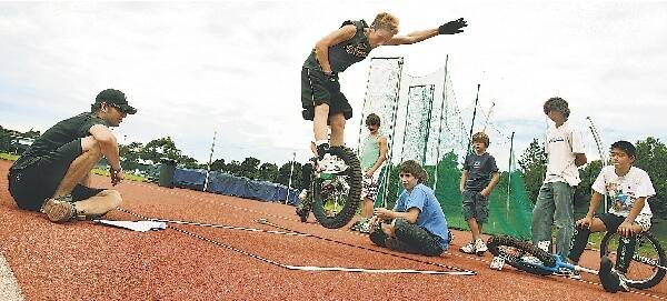 Jaryd Harris, from Tahmoor, competes in the Unicycle Long Jump, at Beaton Park. Pictures: ORLANDO CHIODO
