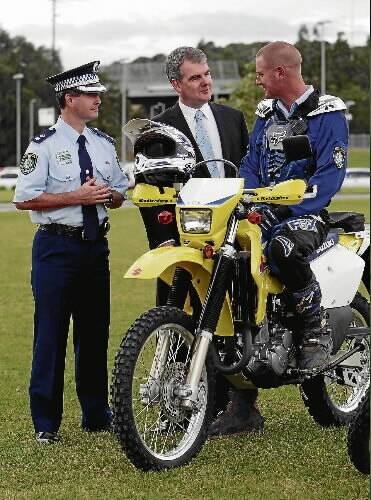 Lake Illawarra commander Superintendent Michael Willing, Police Minister Michael Daley and Senior Constable  Chris St Clair check out a new trail bike yesterday. Pictures: ANDY ZAKELI