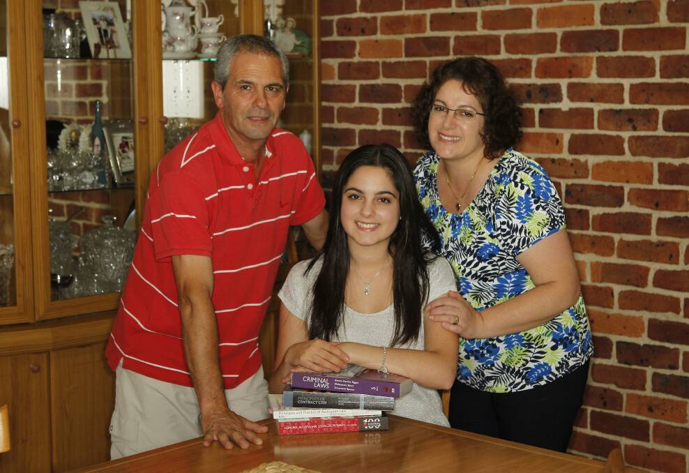 University of Wollongong student Laura Porto with her parents Nello and Carmel at their Coniston home. Ms Porto is doing a double degree in law and commerce. Picture: ANDY ZAKELI
