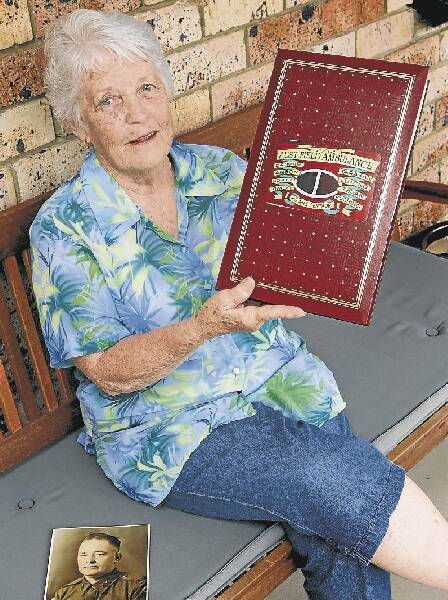 Lucy Walton, of Thirroul, holds a photographic record of father Clem Woods. Picrture: KIRK GILMOUR