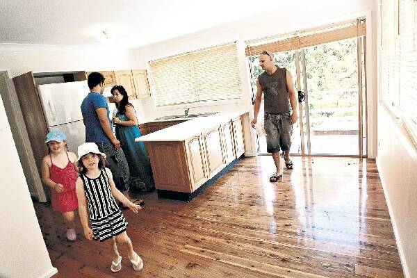 Prospective buyers look at a property in Figtree. Picture: KEN ROBERTSON