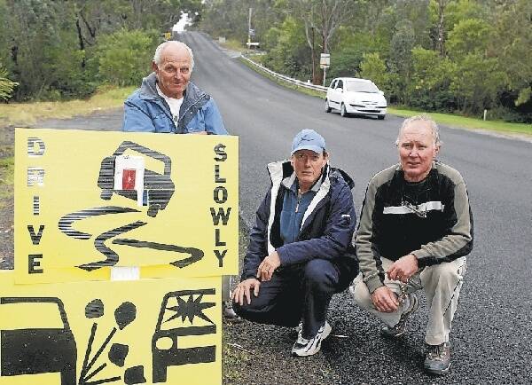 Residents Rick Povet, Jeff Irving and Des OBrien say the newly resurfaced road at Stanwell Tops is rutted and cracked. Pictures: HANK van STUIVENBERG