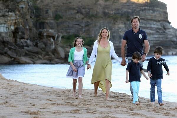 Vicki and Dave Tanner and their children (from left) Sarah, Charlie and Liam enjoy a walk along the beach at Stanwell Park. Picture: MELANIE RUSSELL