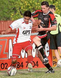 Andres Gomez of the Wolves (left) holds off a challenge from Blacktown City's Kain Rastall.