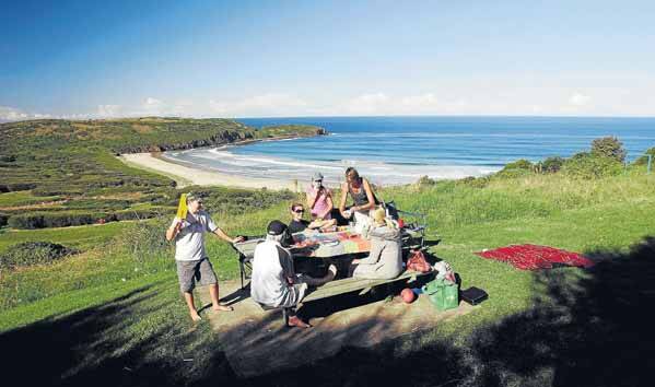 Beholding beauty: The Dill family enjoys a picnic in an area of Killalea State Park where an eco-resort was earmarked for development. Picture: ANDY ZAKELI