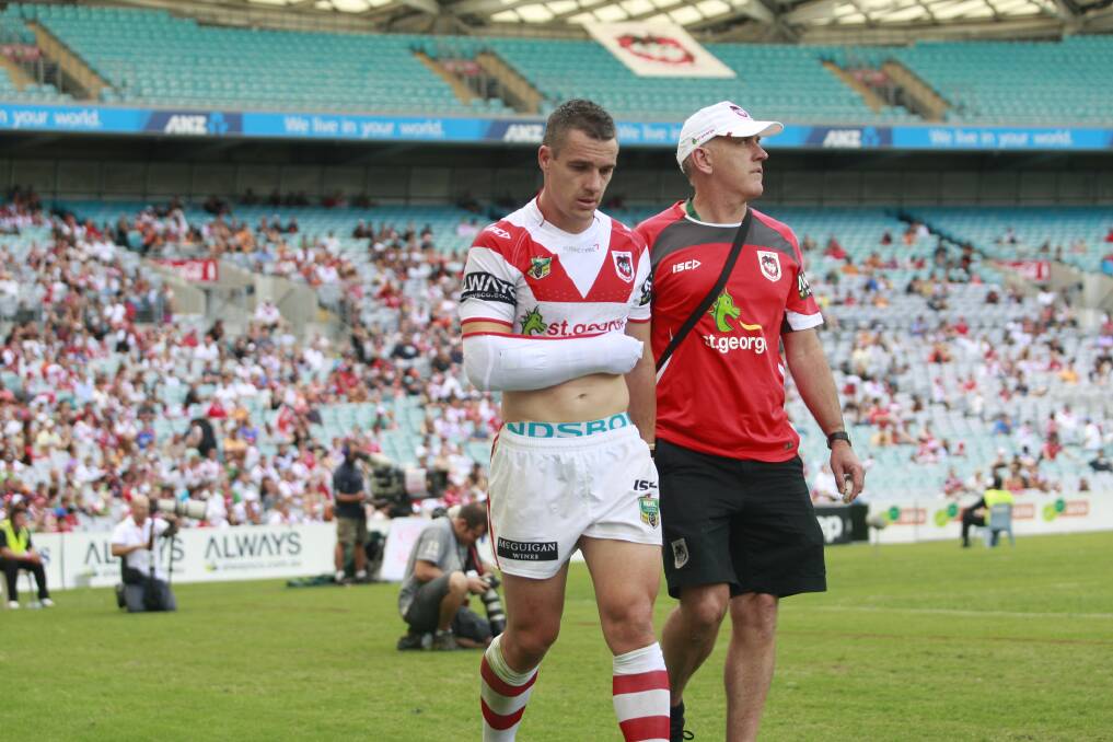 A disconsolate Michael Witt is taken off the field at ANZ Stadium yesterday. Picture: CHRISTOPHER CHAN