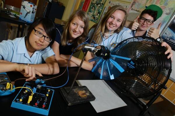 Corrimal High School Year 10 students, Melissa Leung, Brighid Walton, Eryn Chaseling and Raphie Burrett try out some of the new science equipment that focuses on developing renewable energy. Picture: KEN ROBERTSON