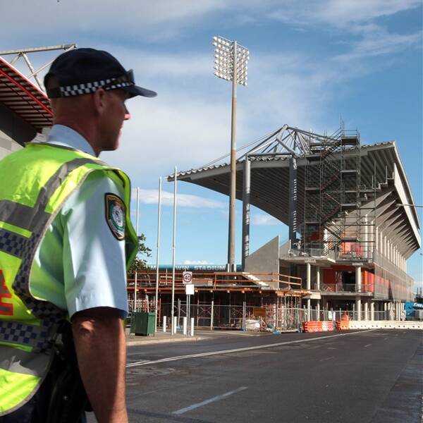 Police clear the area after WIN Stadium's western grandstand roof buckles following strong winds yesterday afternoon. Picture: KIRK GILMOUR