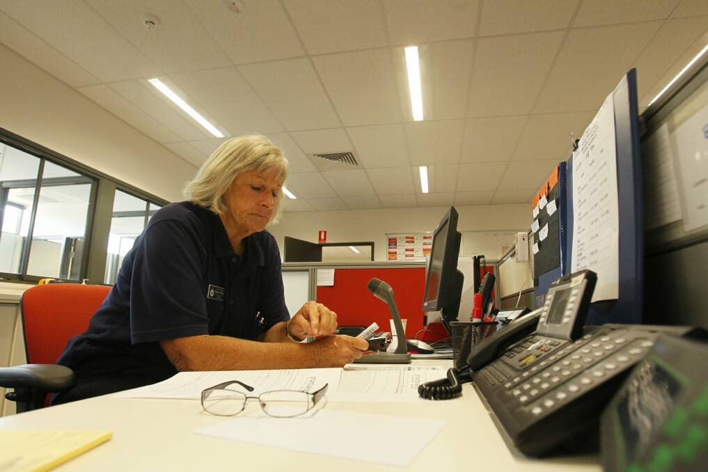 Radio control officer Norell Pullen mans the emergency radios at the RFS control centre. Pictures: DAVE TEASE