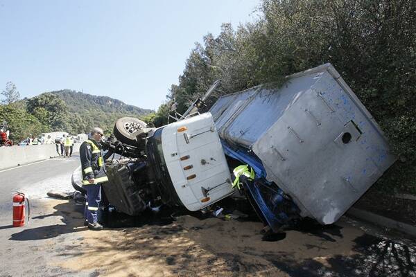 The jackknifed semitrailer came to rest 500m south of the Mount Pleasant overpass on Mt Ousley Rd. Pictures: DAVE TEASE