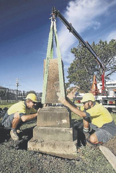 Stonemasons Grahame Ewings and Sach Killam work on the historic graves that had been vandalised in Wollongong Cemetery. Picture: KIRK GILMOUR