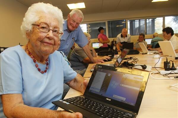 Jean Kells, 92, tries out the new NBN internet connection at the Kiama Municipal Library. Picture: DAVE TEASE