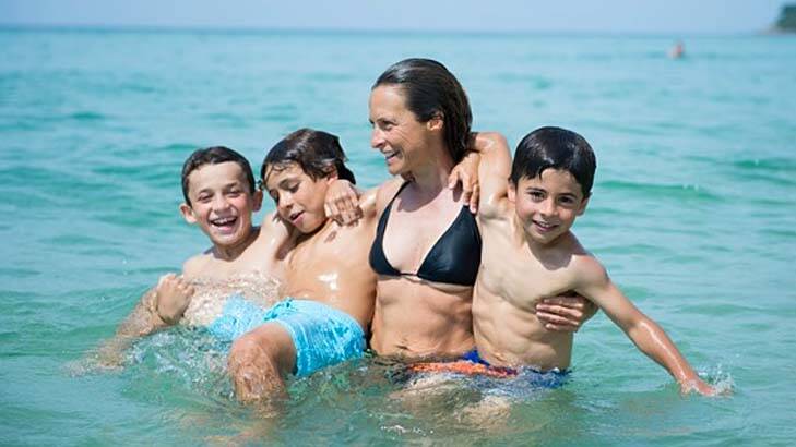 Close family: Sam Bloom swimming with her three sons, Rueben, Noah and Oliver. Photo: Cameron Bloom