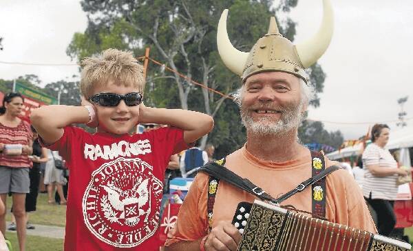 Freddie Fallows, 6, of Bulli - obviously a fan of '80s punk rock - wasn't that interested in what Stuart Leslie from Nowra-based band The Puddin' Eaters' had to play. Pictures: GREG TOTMAN