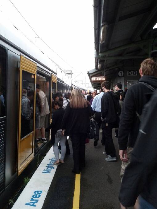 Commuters queue at Waterfall for a train to Sydney this morning. Photo: MATT JONES