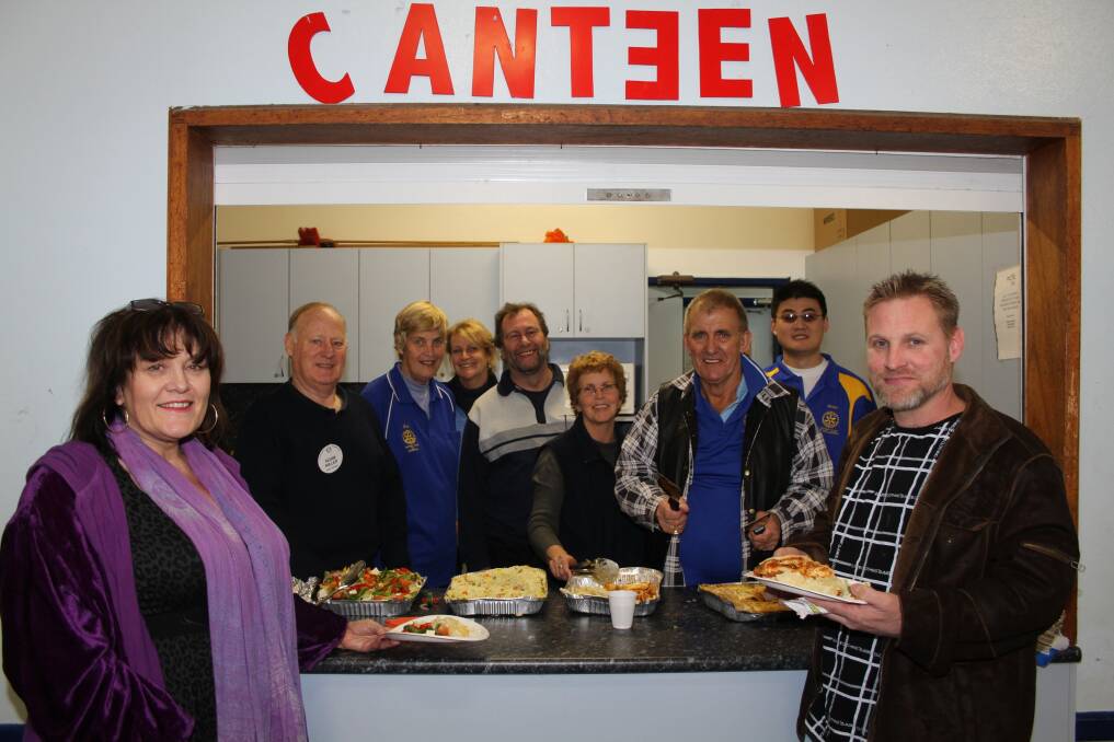 Lee Taylor and Sue Phillips help Rotarians from around Wollongong to serve meals to dozens of teenagers.