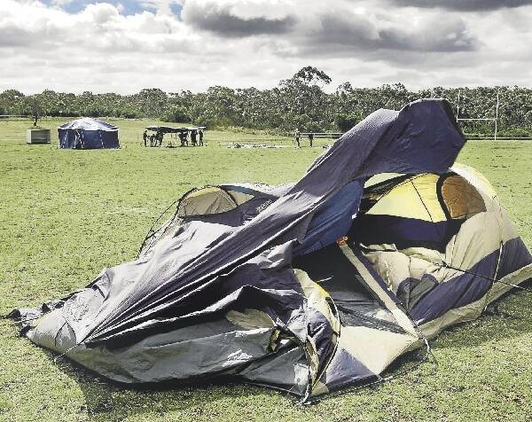 Patience tested: Wild winds have caused havoc for campers putting up tents in Helensburgh in preparation for Climate Camp. The three day event is aimed at stopping the expansion of the Metropolitan Colliery. Picture: KIRK GILMOUR
