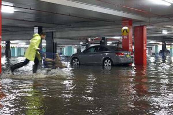 Westfield Warrawong's car park is struck by rising water levels as staff rush to sandbag entrances. Picture: ANDY ZAKELI