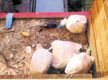 Rubbish bags pile up outside the complex. Picture: CHRISTOPHER CHAN