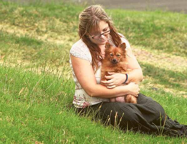 Wendy Boreland, girlfriend of owner Velko Bozinovski, with Chelsea the pomeranian, whose three pups were stolen from his Cringila home on Thursday night. The puppies were valued at around $5000.Picture: DAVE TEASE