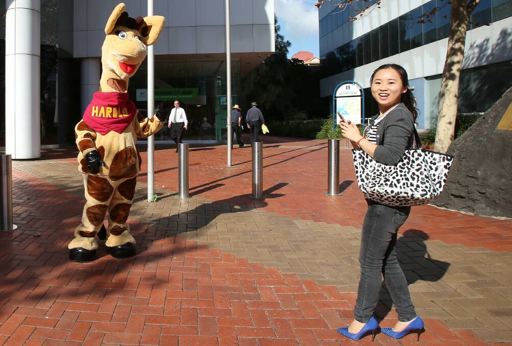 Delight: Leta Jiang, a visitor from China, takes a snap of Healthy Harold. Picture: KIRK GILMOUR