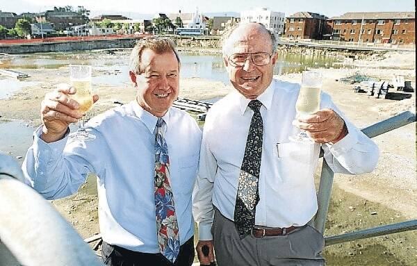Peter Brettell (left) and Peter Bolt toast news of the start of works for the WEC in April 1997, which guaranteed the Hawks' future in the NBL. Just 10 years later the club has been priced out of the NewNBL.