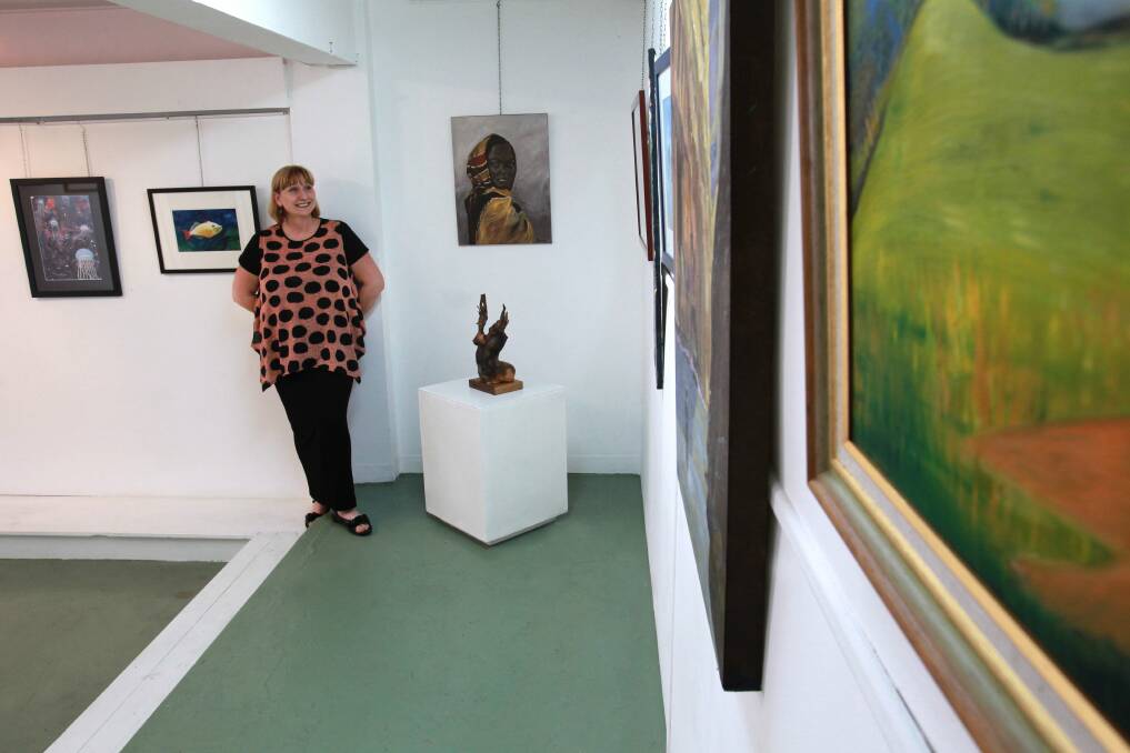 Art Arena Gallery and Studio president Kylie Sweeney de Havilland looks over the Voyagers Verge exhibition. Picture: ORLANDO CHIODO