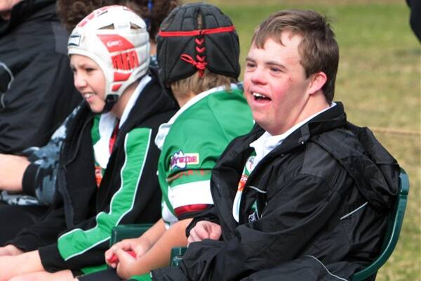 Brenton Ashford-Potter coaches kids' football, does judo, surfs, and helps out with the local theatre company. He has Down syndrome, and says he's living his dream. He's pictured above and below with the Woonona under 13 Bushrangers. Picture: GREG TOTMAN 